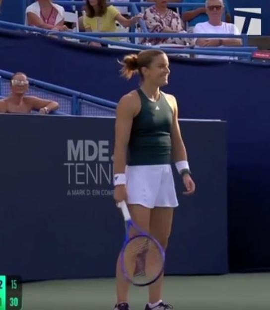 Tennis player holding racket on court.