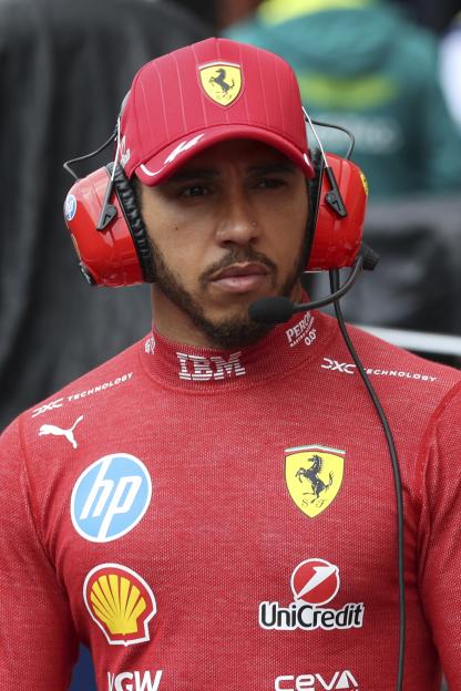 Lewis Hamilton in Ferrari racing gear during a rain delay.