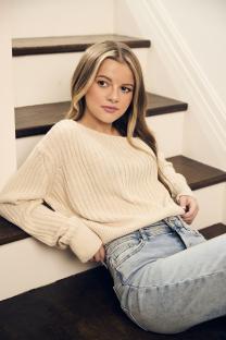Portrait of Heide Katona sitting on stairs.