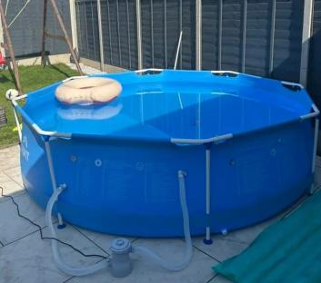 Family-sized inflatable pool in a backyard.