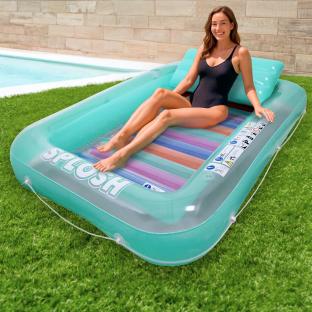 Woman relaxing on a teal inflatable pool lounger.
