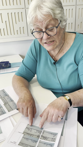 Woman reviewing handwritten forms.