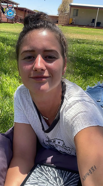 Photo of a young woman lying on the grass.
