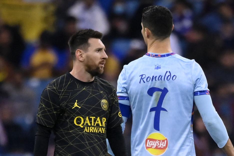 TOPSHOT - Paris Saint-Germain's Argentine forward Lionel Messi (L) walks past Riyadh All-Star's Portuguese forward Cristiano Ronaldo (R) during the Riyadh Season Cup football match between the Riyadh All-Stars and Paris Saint-Germain at the King Fahd Stadium in Riyadh on January 19, 2023. (Photo by FRANCK FIFE / AFP) (Photo by FRANCK FIFE/AFP via Getty Images)