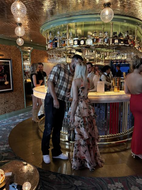 Shea and Sacha kissing at a bar.