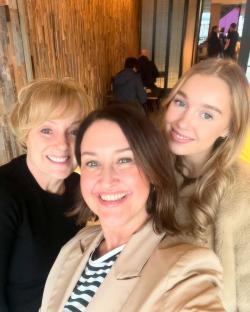 Three women posing for a selfie.