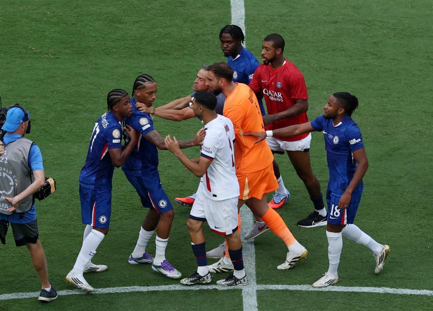 Soccer players arguing on the field.