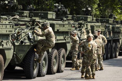 US soldiers preparing Stryker armored vehicles for a military parade.