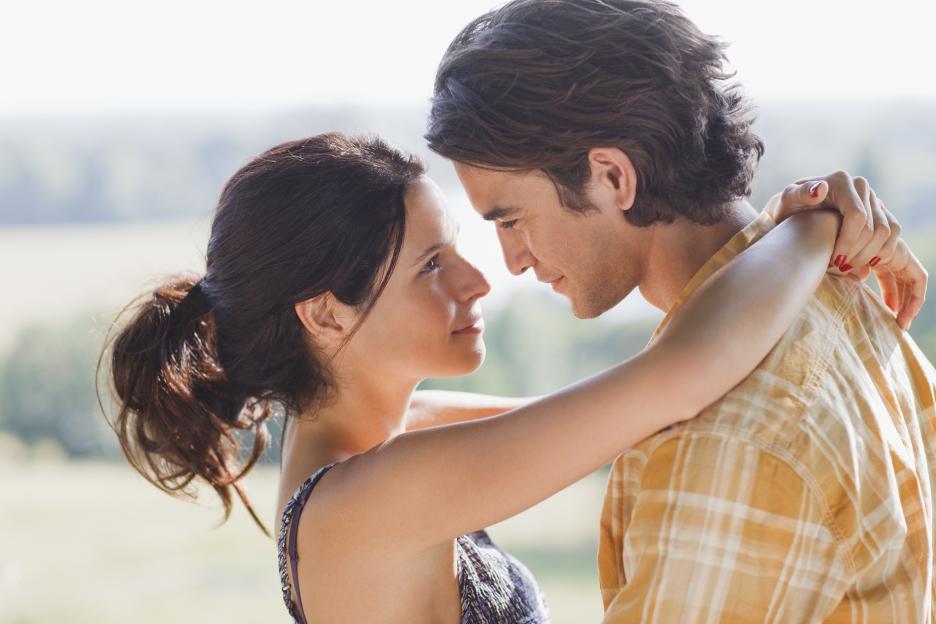 Young couple embracing outdoors.