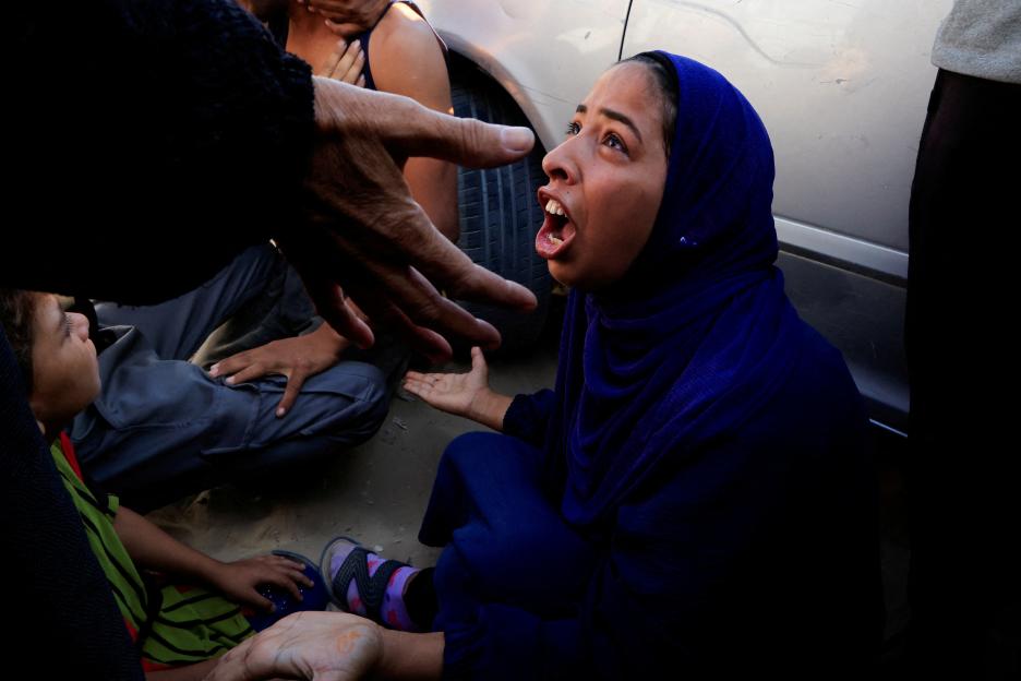 Woman mourning at hospital after deadly incident in Gaza.