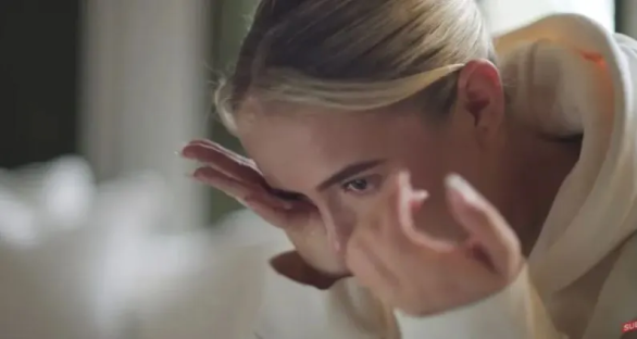 Woman rubbing her eyes.