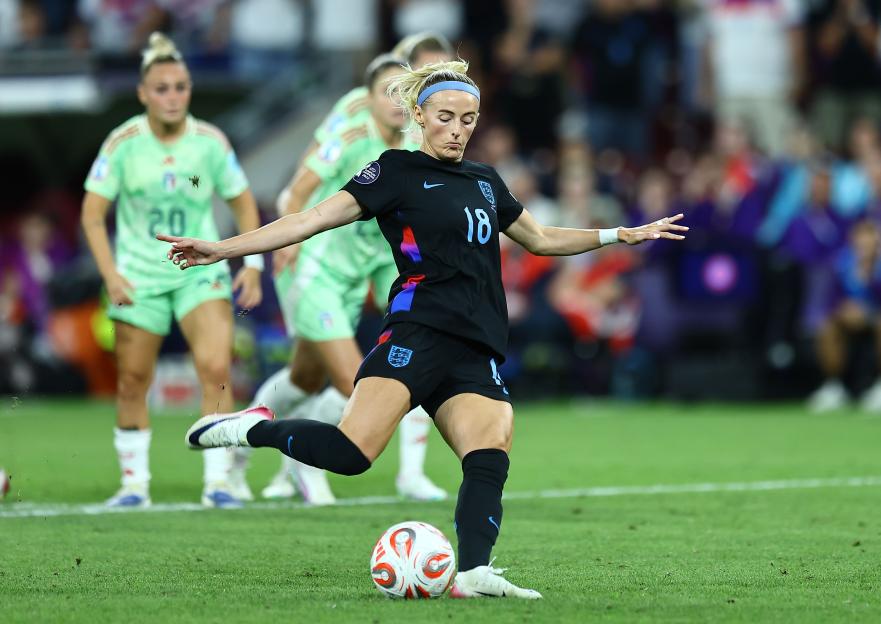 Chloe Kelly of England taking a penalty kick during a soccer match.