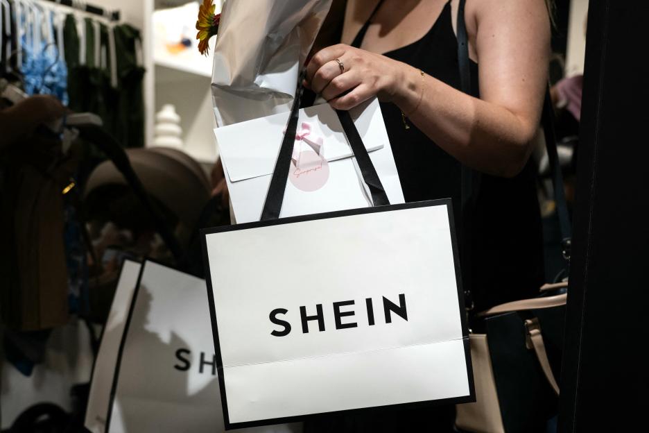 Woman holding Shein shopping bag.