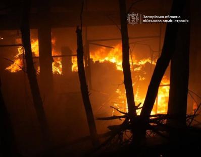 Industrial and residential buildings burning in Zaporizhzhia after a Russian attack.