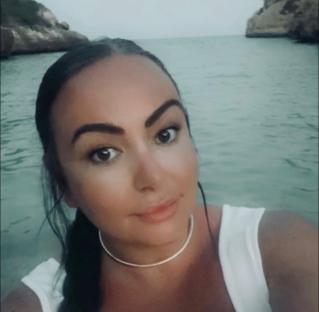 Christina Corish in a white top by the water.