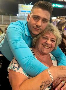 A young man hugging an older woman.
