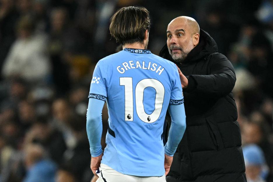 Pep Guardiola talking to Jack Grealish.