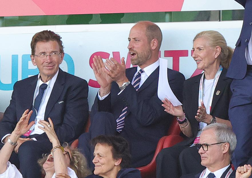 Prince William clapping at a soccer game.