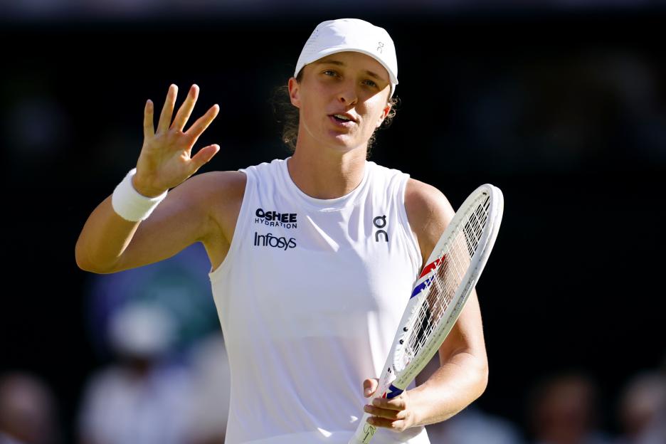Iga Swiatek of Poland acknowledges the crowd after a Wimbledon semi-final win.