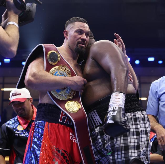 Joseph Parker and Martin Bakole embracing after a boxing match.