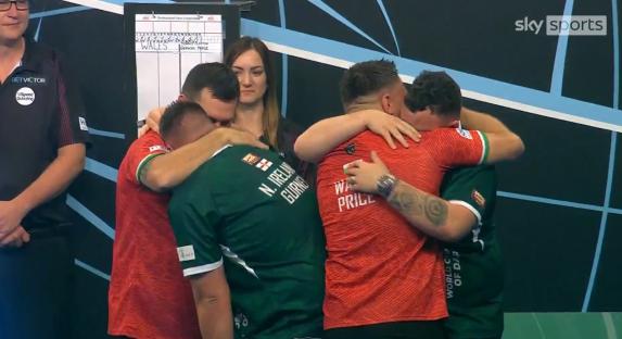 Northern Ireland's Daryl Gurney and Josh Rock embrace teammates after winning the World Cup of Darts.
