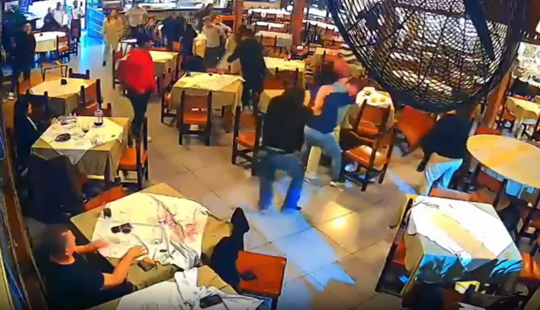 A fight breaking out in a restaurant.