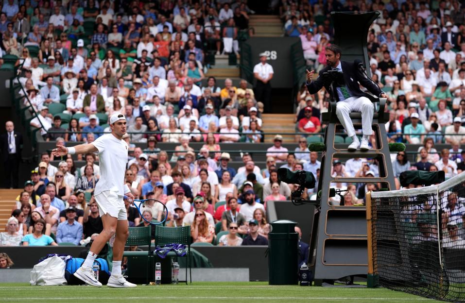 Jack Draper arguing a line call with the umpire at Wimbledon.