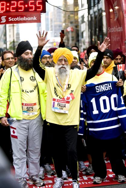Fauja Singh, 100, celebrating after completing a marathon.