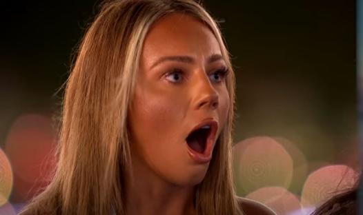 A woman with blonde hair looking shocked.