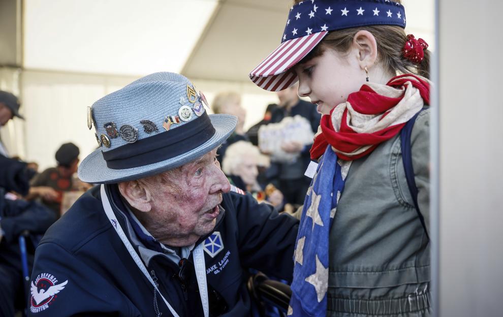 Veteran talking to a girl wearing an American flag.