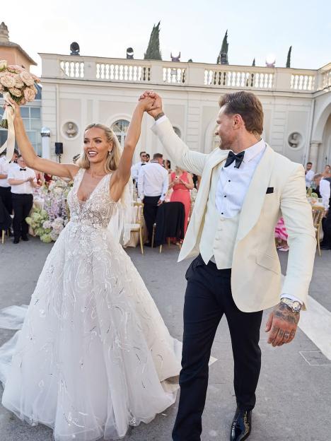 Bride and groom holding hands at their wedding.