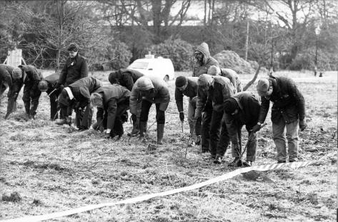 Police searching the grounds of Kenneth Noye's home.