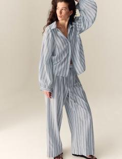 Model wearing light blue striped pants and shirt.