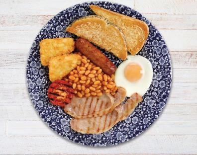 Full English breakfast on a patterned plate.