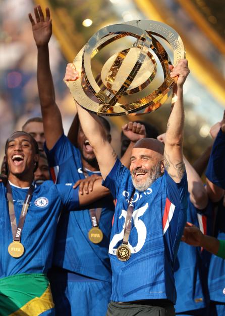 Chelsea FC coach Enzo Maresca lifts the FIFA Club World Cup trophy.
