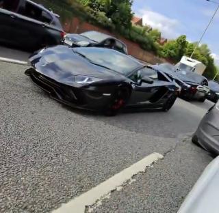 A black Lamborghini in London traffic.