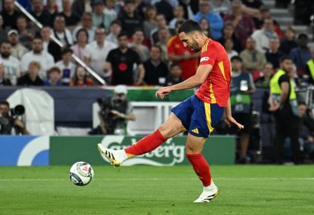 Mikel Merino of Spain scoring a goal during a soccer match.