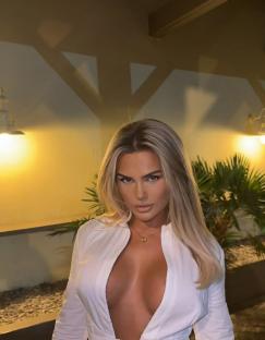 Woman in white shirt outdoors at night.