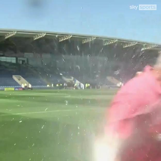 Sky Sports reporter drenched by sprinkler during live broadcast.