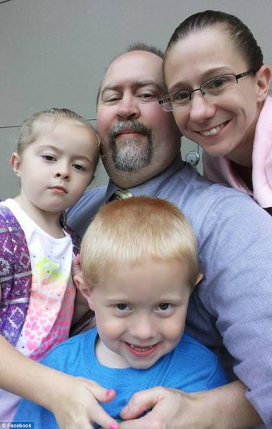 Family portrait of two parents and their two young children.