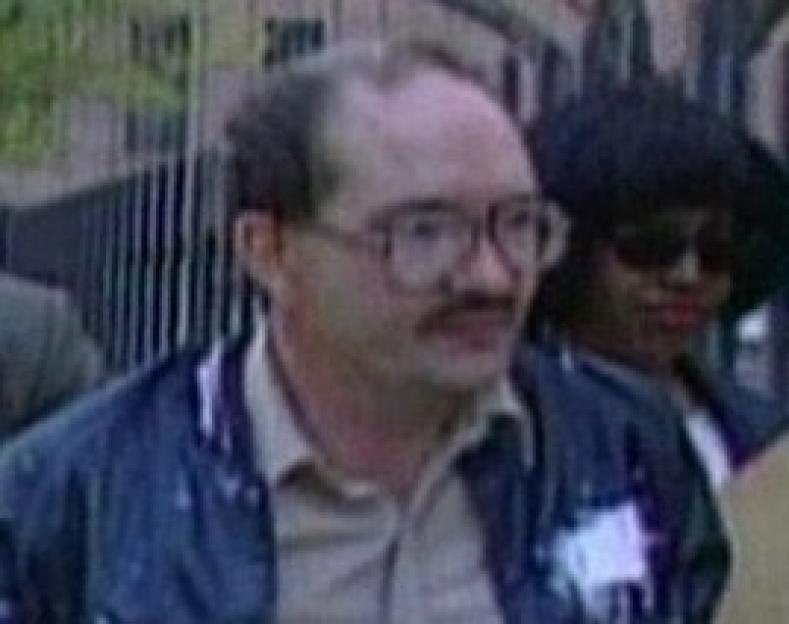 Close-up of a man with glasses and a mustache.