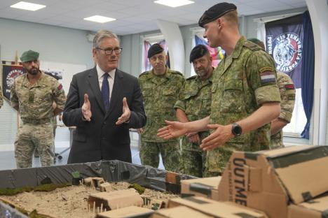 Prime Minister Keir Starmer at a military base, viewing a model encampment.
