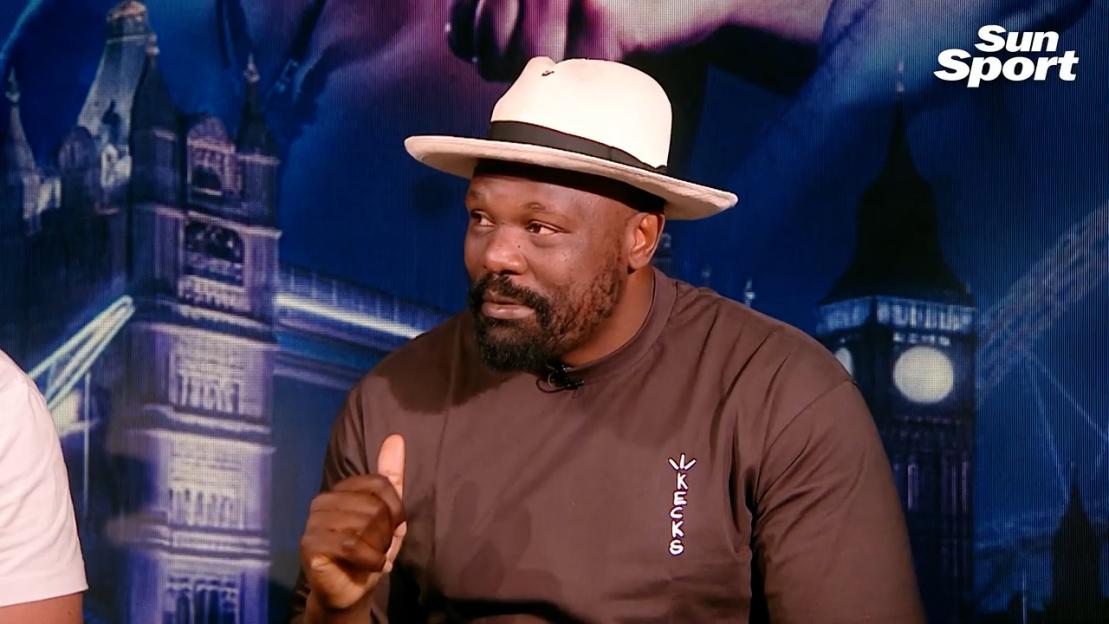 Man in hat giving thumbs up.