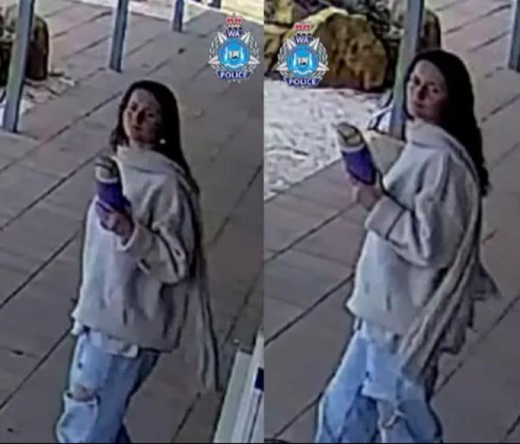 Surveillance image of a woman holding a purple item.