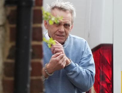 Graham Head in handcuffs.