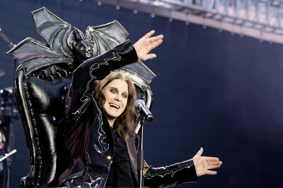 Ozzy Osbourne on stage in a bat-winged chair.