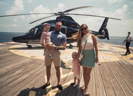 Conor McGregor with his wife and two children on a helicopter pad.