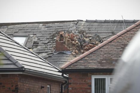 Damage to a house roof after a suspected gas explosion.