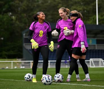 Three England women's soccer goalkeepers during a training session.