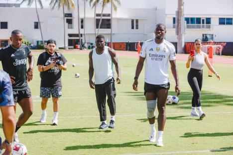 Paul Pogba on a soccer field with others.
